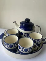 blue and white color teapot along with 4 cups