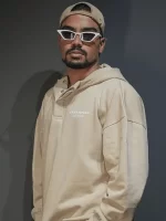 A male model posing wearing beige color unisex hoodie.